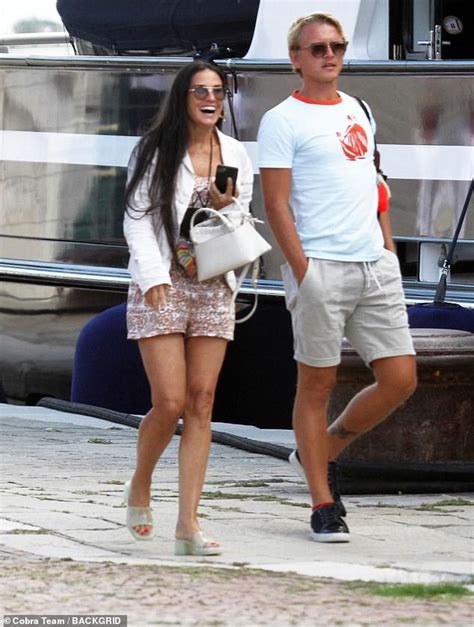demi moore 58 puts on a leggy display in a paisley playsuit and chuckles with a male companion