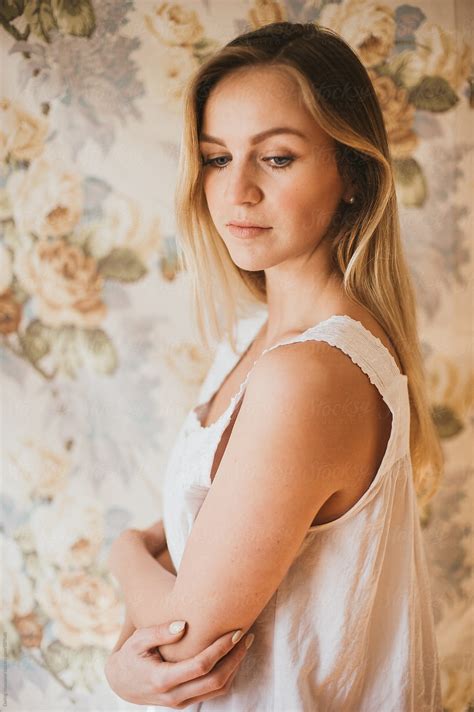 Portrait Of Pretty Young Blonde In Vintage White Dress And Floral