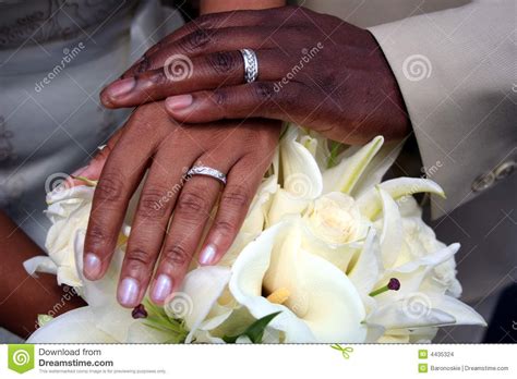 Picture With Black Couples Hands With Wedding Rings On A Bouquet An
