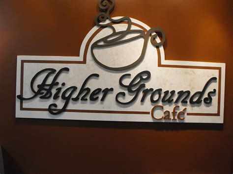 A Sign That Says Higher Grounds Cafe On The Side Of A Wall With A