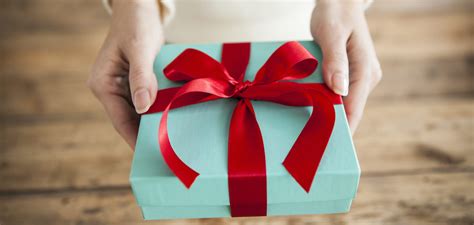 The Woman Is Handing A Gift Box Designability