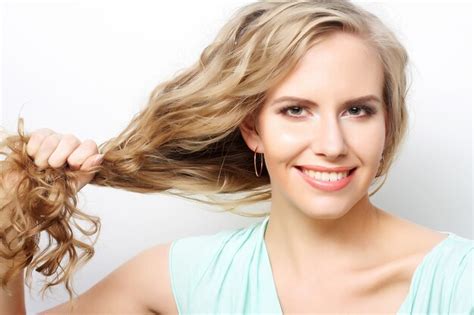 premium photo woman holding her long curly healthy hair