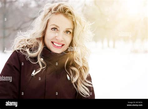 Blond Woman In Winter Landscape With Sun Flare Stock Photo Alamy