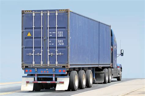 Semi Truck Hauling A Large Shipping Container Stock Photo Download