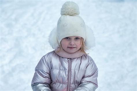 Winter Portrait Happy Little Girl In Snowy Public Park In Warm Clothes