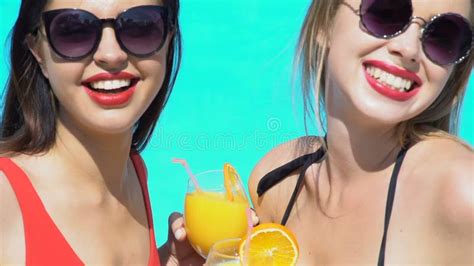 Two Ladies Clinking Cocktails And Looking At Camera Near Swimming Pool Stock Video Video Of