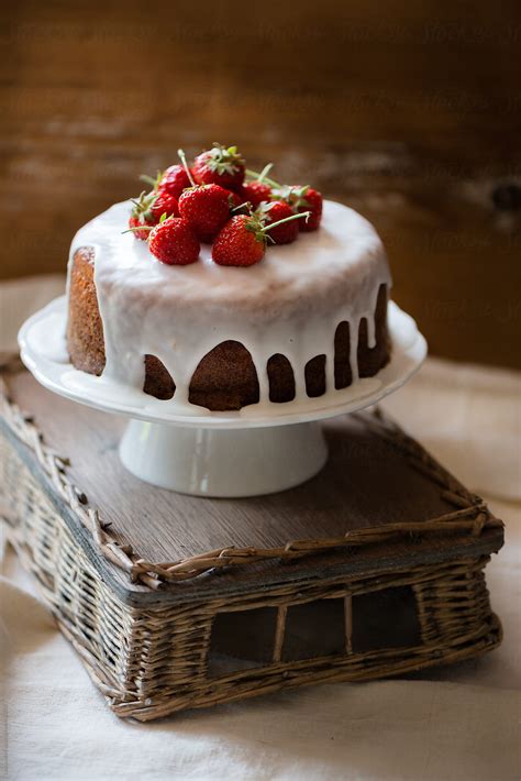 cake with icing and strawberries by stocksy contributor laura adani stocksy