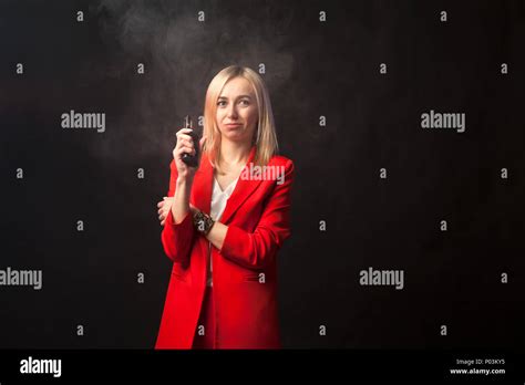 Young Beautiful White Blond Girl In A Bright Red Strict Suit With A Jacket And White Blouse