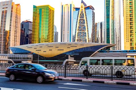 Metro Railway Among Among Glass Skyscrapers In Dubai Traffic On Street