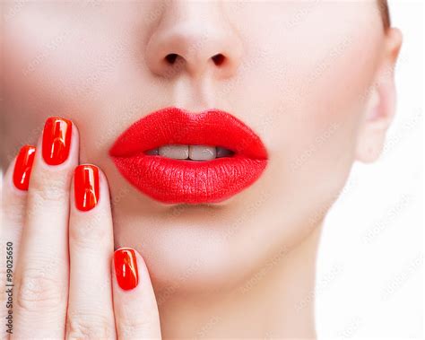 red sexy lips and nails closeup open mouth manicure and makeup make up concept kiss