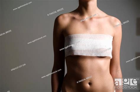 Mid Section View Of A Woman S Nipples Covered With Adhesive Bandages