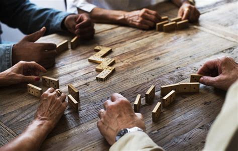 Group Of People Playing Domino Game On Wooden Table Stock Image Image