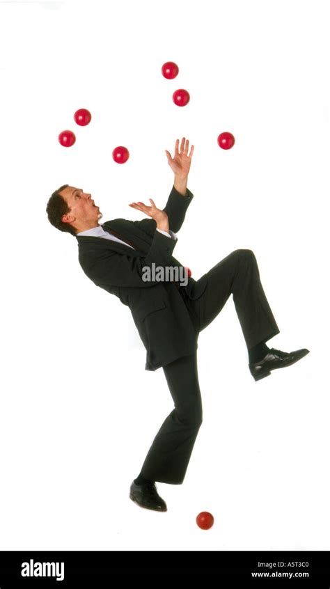Business Man Juggling Unsuccessfully To Juggle Multiple Red Balls One
