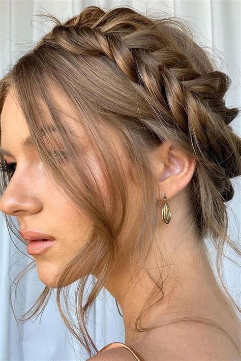 wedding hairstyle trends updo with braided crown on brown hair with loose curls sarahneillhair