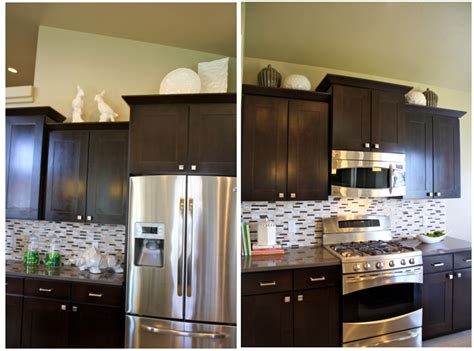 Excellent lighting and the warm, neutral color of the walls and cabinets help to keep everything above the cabinet in sight and in mind. How to Decorate Above Kitchen Cabinets ~ shaweetnails