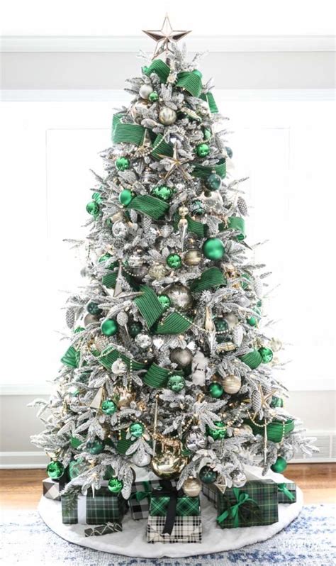 A White Christmas Tree With Green And Silver Ornaments