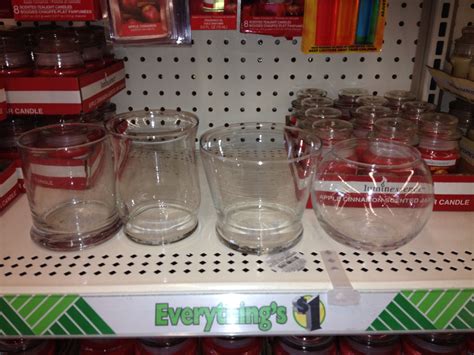 There Are Many Glasses And Jars On The Shelf In The Store All Lined Up