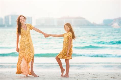 Premium Photo Beautiful Mother And Daughter At The Beach Enjoying
