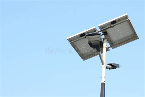 Street Lamp Post With Solar Panel Energy Against Blue Sky Background