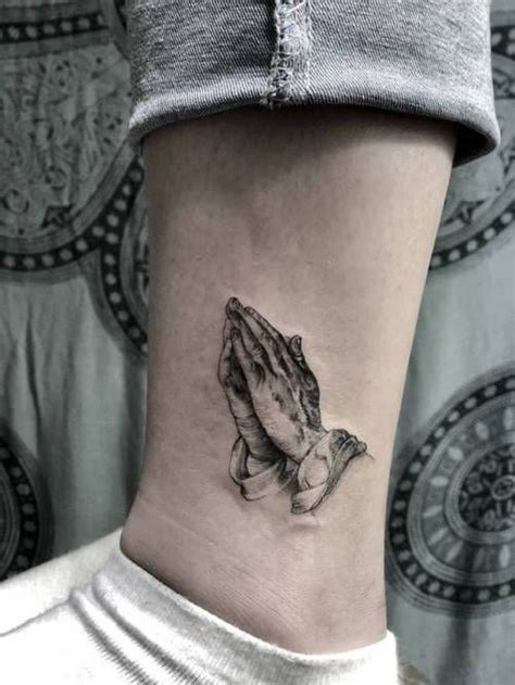 A Womans Ankle With A Small Praying Hand Tattoo On Her Left Side Ribcage