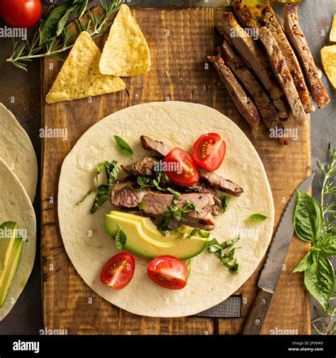 Making Tacos With Grilled Steak Avocado And Tomatoes Mexican Food