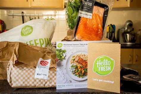 Hello Fresh Meal Kits Packed In Paper Bags Woman`s Hands Holding