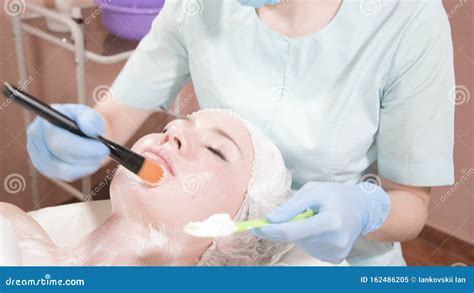 The Girl A Cosmetologist Performs The Procedure Of Cleansing And