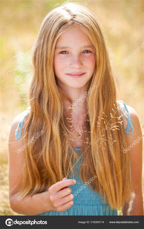 Portrait Of A Beautiful Young Blonde Little Girl Stock Photo By