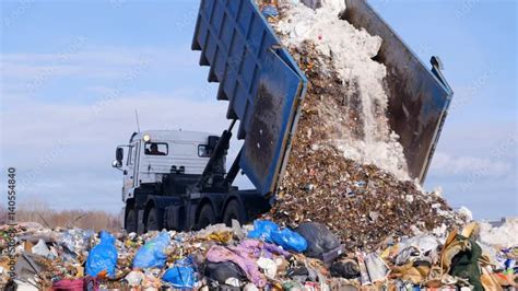 Garbage Truck Disposed Trash On The Landfill Vehicle Transporting