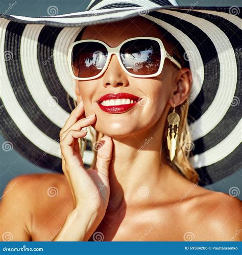 Portrait Of A Beautiful Young Woman Wearing Hat And Sunglasses Stock