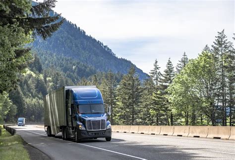 Convoy Of Blue Big Rigs Semi Trucks With Semi Trailers Transporting