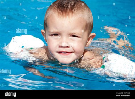 Portrait Of Little Baby Boy Swimming In The Swimming Pool Stock Photo