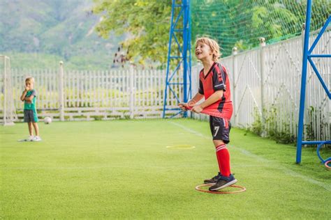 Young Boys Playing Football Soccer Game Running Players In Uniforms