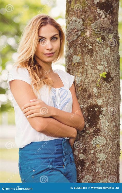 Beautiful Woman With Arms Crossed Standing By Tree Stock Image Image