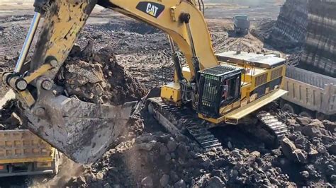 Caterpillar D Excavator Loading Trucks With Two Passes Interkat SA YouTube