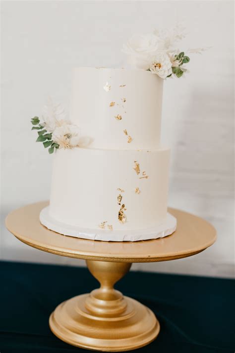 Simple Two Tiered White And Gold Flake Wedding Cake Wedding Cake