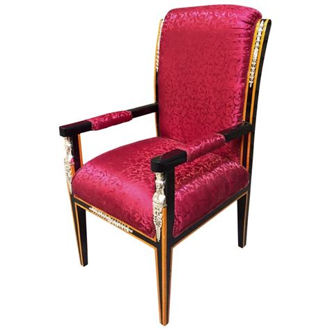 Will be arranged by the facility. Grand Empire style armchair red satin fabric and black ...