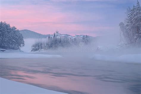 The Castle Which Stands On The Bank Of A Frozen River Stock Photo
