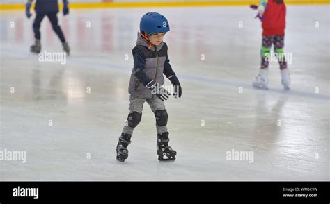 Boy Ice Skating On Rink Stock Photo Alamy