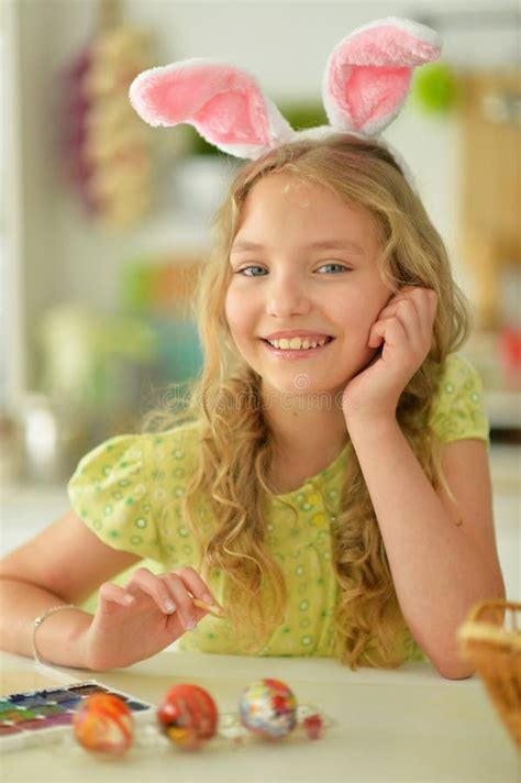 Beautiful Girl In Bunny Ears Painting Eggs For Easter Holiday Stock