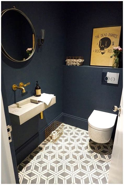 A Cool Guest Toilet With Navy Walls A Geometric Floor An Artwork And
