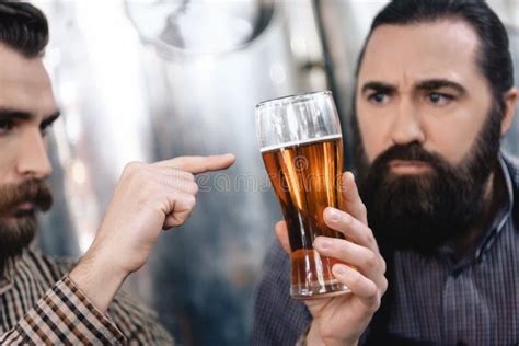 Two Adult Bearded Brewers Are Testing Beer Quality Control Of Beer