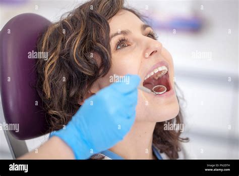 Beautiful Patient In The Dental Chair The Doctor Examines Her Teeth Stock Photo Alamy