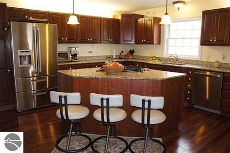 Design a kitchen island with seating that invites family members and guests to pull up a chair or stool and share conversation while you're cooking. Triangle island, now that's an idea. | Kitchen remodel ...