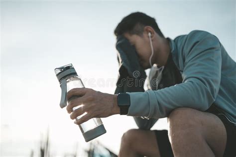 Sport Man Sitting After Running And Holding Water Bottle Drink Sport