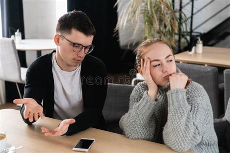 Annoyed Man Trying To Explain Something To His Wife Stock Photo Image
