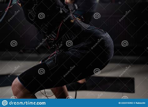Girl In EMS Suit In Gym Sport Training In Electrical Muscle