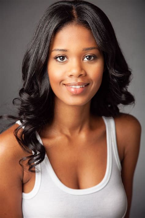 Beautiful Black Actor Actress Headshot Smiling Against Dark Grey Background Photographed In NYC