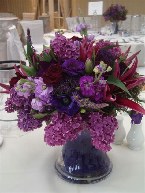 Belonging to the iris family, the meaning of flowers: Vase centrepiece of deep purple and plum stocks, lilac ...