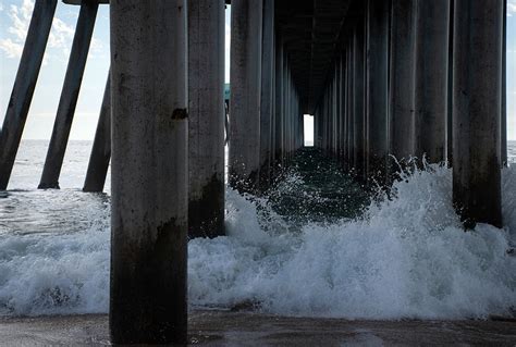 Waves Crashing Against The Huntington Beach Pier Photograph By Riley